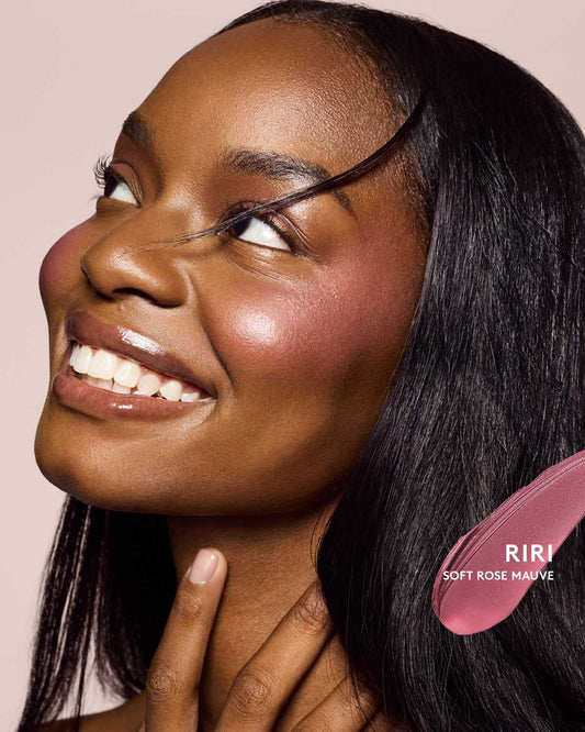 deep skin toned model wearing cheeks out freestyle cream blush in shade riri
