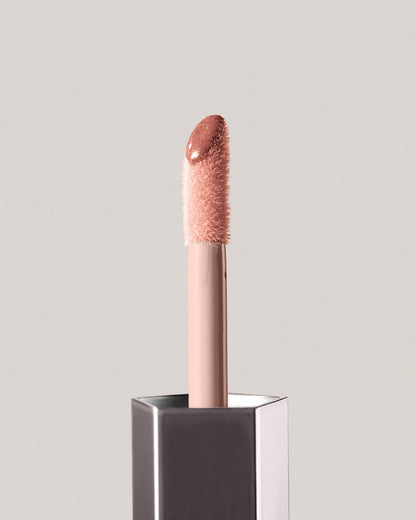 Fenty Beauty GLOSS BOMB UNIVERSAL LIP LUMINIZER in shade Fenty Glow close up of doe foot applicator