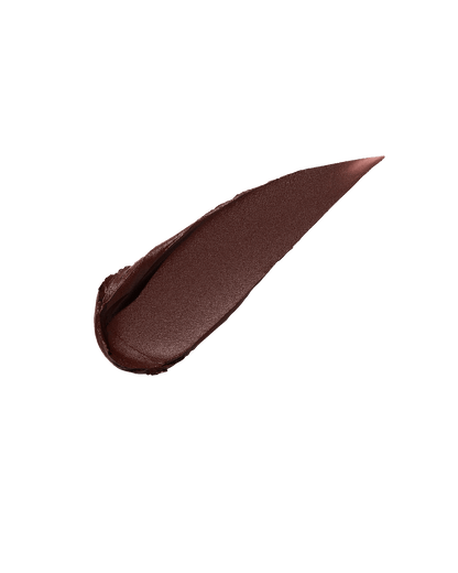 A smear of Fenty Icon Velvet lipstick in deep brown color on a light background.