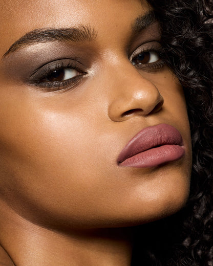 medium skin toned model wearing stunna lip paint in the shade uncuffed