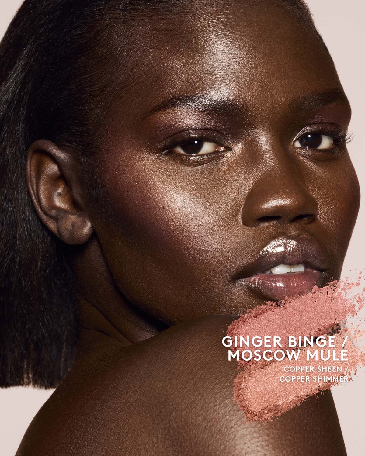 deep skin toned model wearing killawatt freestyle highlighter in shade ginger binge/moscow mule