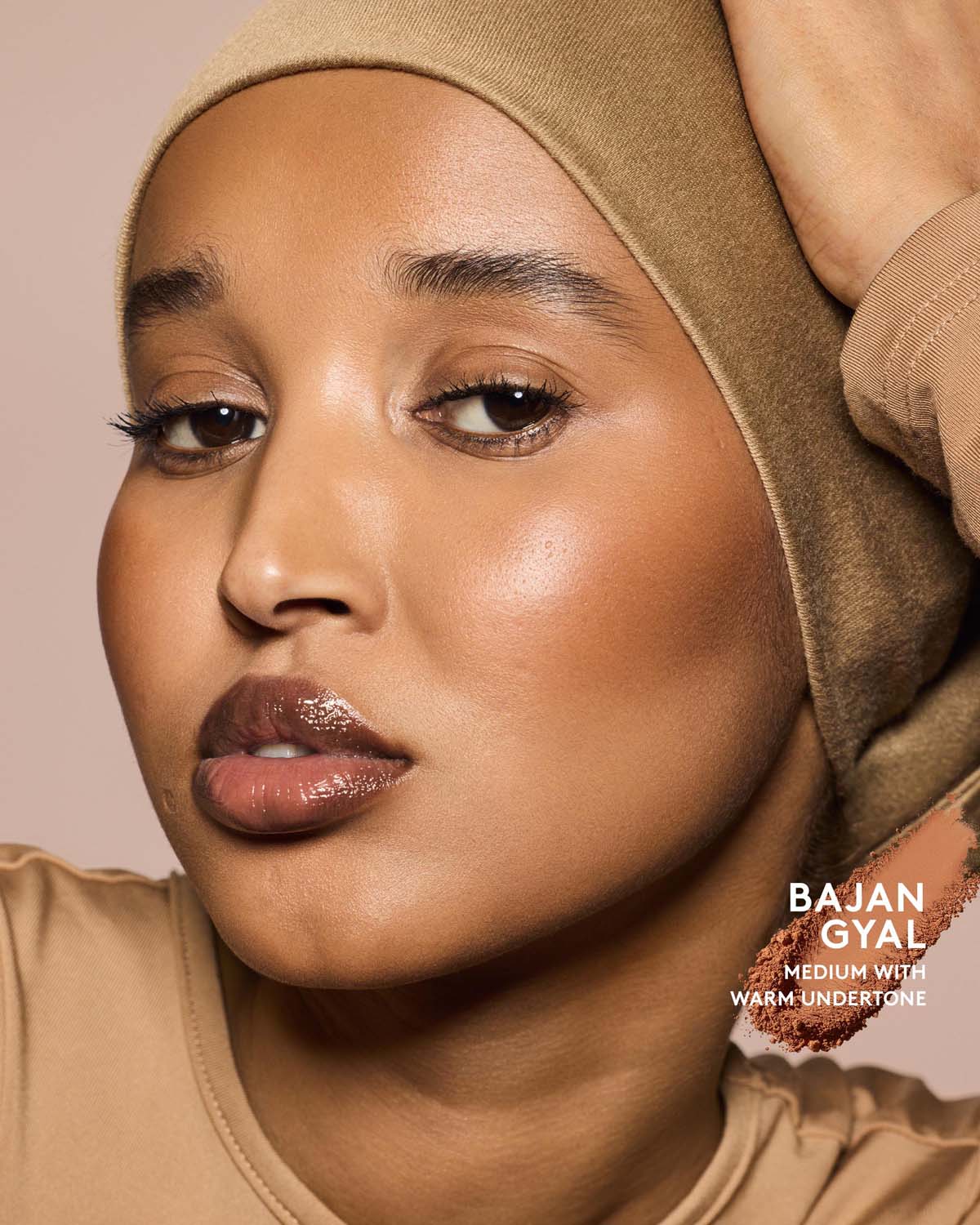 Medium skin tone model wearing sun stalk'r bronzer in shade Bajan Gyal.