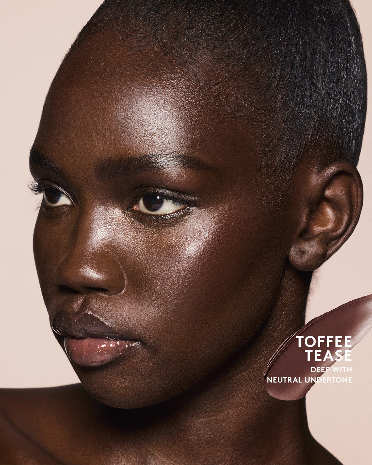 Deep skin tone model wearing cheeks out bronzer in shade Toffee Tease.