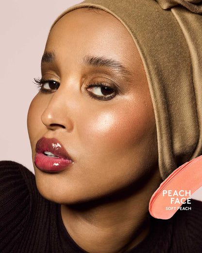 medium skin toned model wearing cheeks out freestyle cream blush in shade peach face