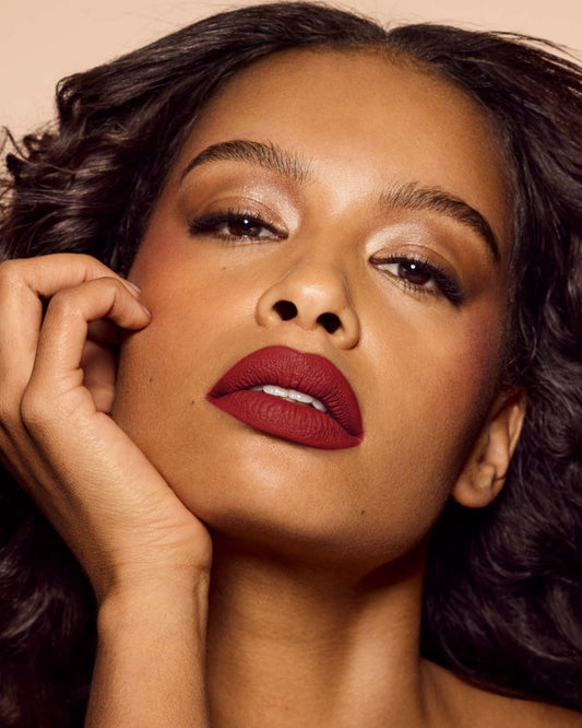 medium skin toned model wearing icon velvet longwear liquid lipstick in shade mvp