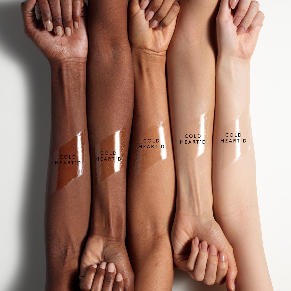 arm swatch of gloss bomb ice against deep, medium deep, medium, light medium, and light skin tones.