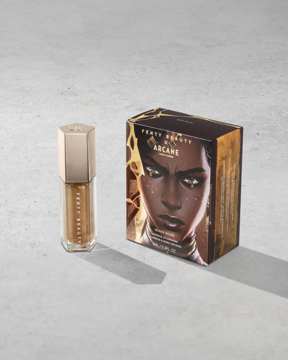 Product shot of Fenty Beauty Gloss Bomb Universal Lip Luminizer and packaging in limited edition Arcane collection shade Risky Ruling.