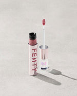 An open Fenty Icon Velvet lipstick tube on a light background.