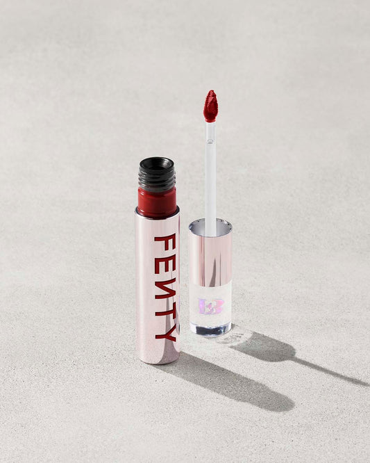 An open Fenty Icon Velvet lipstick tube on a light background.
