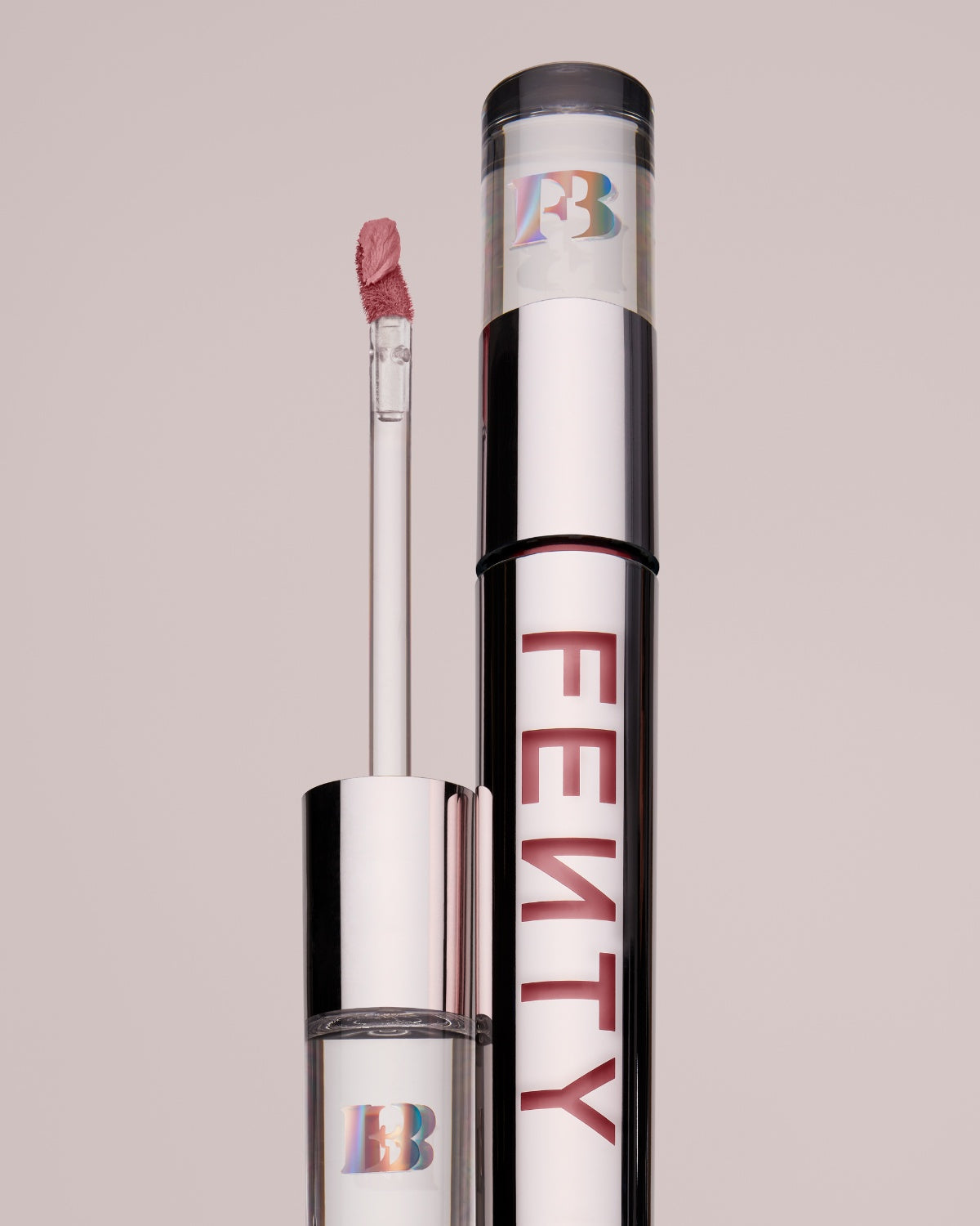 An open Fenty Icon Velvet lipstick tube on a grey background.