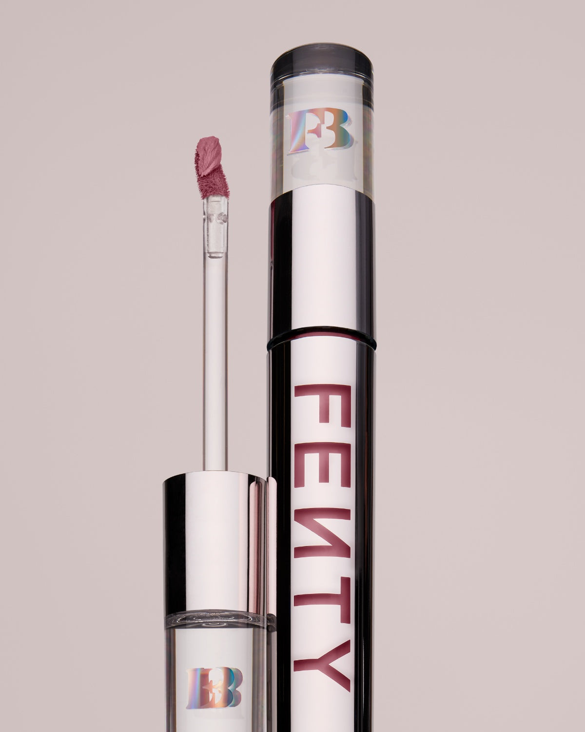 An open Fenty Icon Velvet lipstick tube on a grey background.