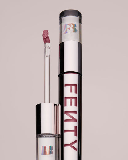 An open Fenty Icon Velvet lipstick tube on a grey background.