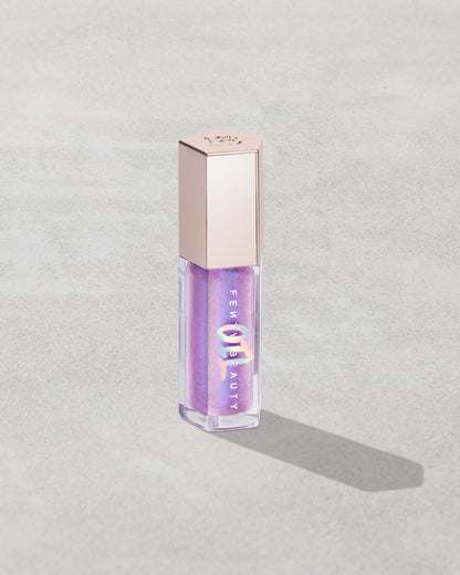 Gloss Bomb Oil Luminizing Oil and Gloss in shade Miss Jellyfish product against a concrete background.