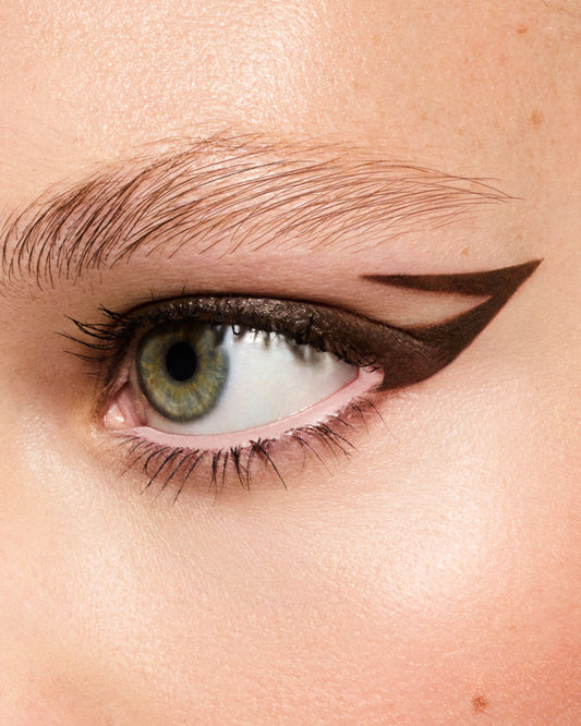 Macro of model wearing Fine Linez Lash-Enhancing Eyeliner in shade 'In Big Truffle'.