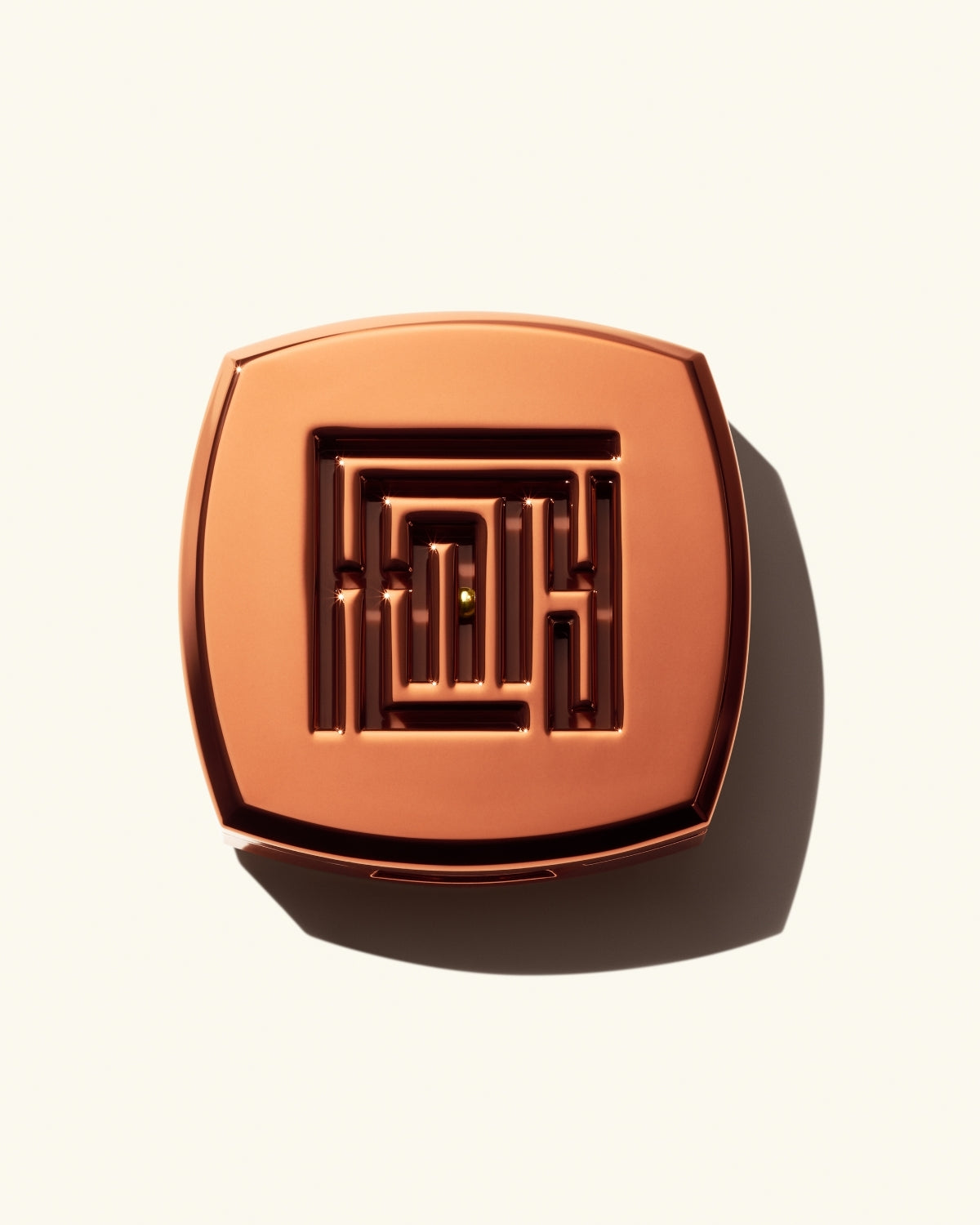 Closed shot of Fenty Fragrance Solid Parfum on a cream background.