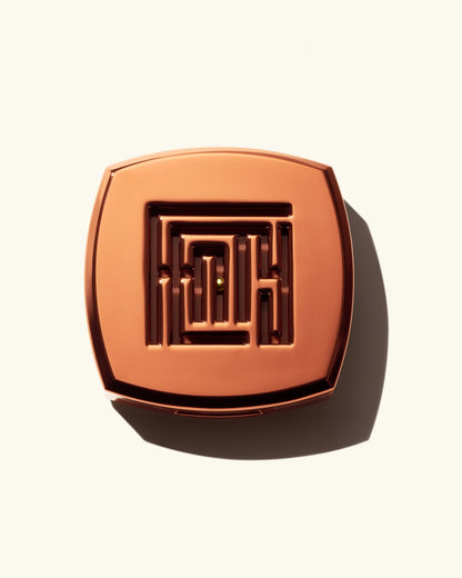 Closed shot of Fenty Fragrance Solid Parfum on a cream background.