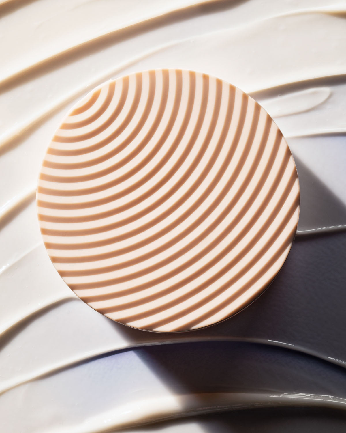 Top of the textured lid with a smear of The Homecurl Curl-Defining Cream.